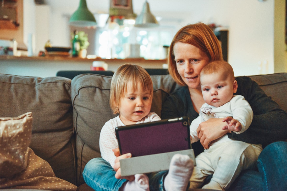 A caring nanny spending quality time with two young children